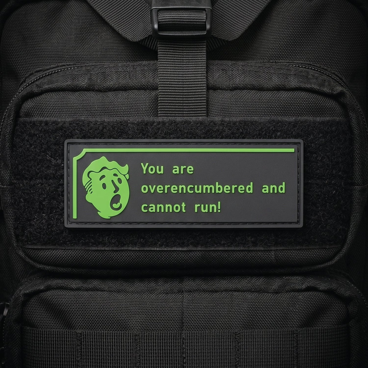 Black rectangular PVC morale patch with bright green text: You are overencumbered and cannot run